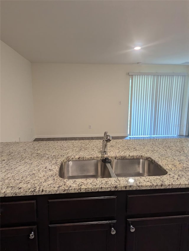 kitchen with light stone counters and sink