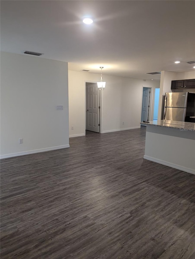 unfurnished living room with dark hardwood / wood-style floors