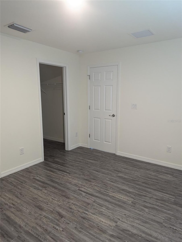 spare room with dark hardwood / wood-style floors