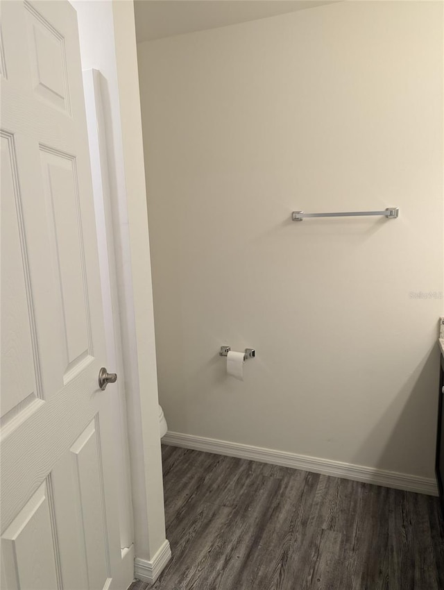 bathroom with hardwood / wood-style floors and toilet