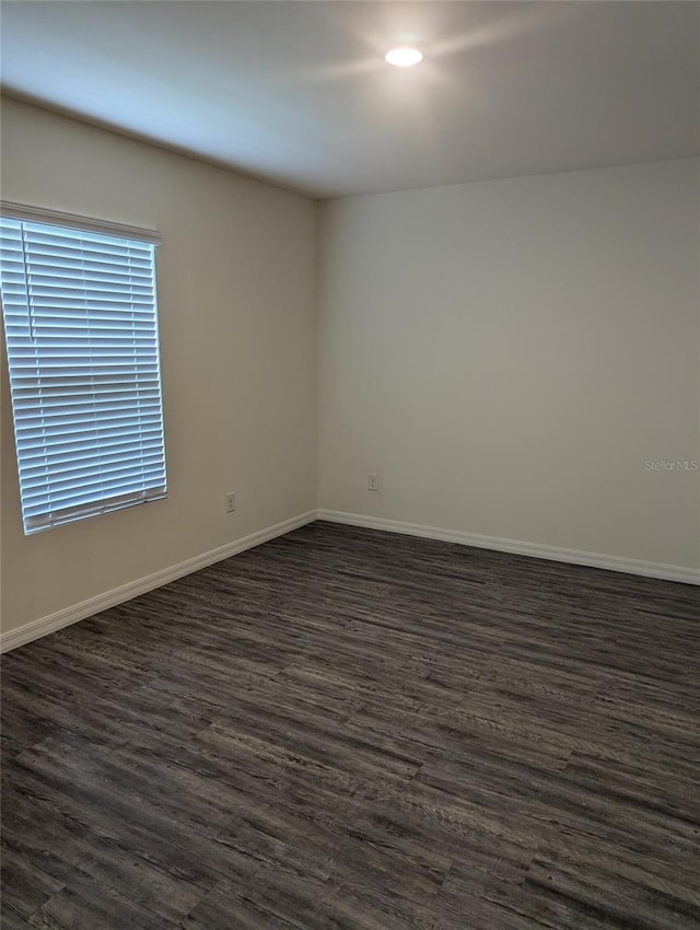 unfurnished room with dark hardwood / wood-style floors