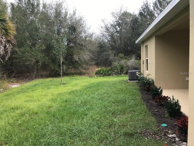 view of yard featuring central air condition unit