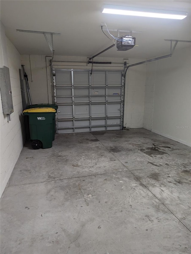 garage with a garage door opener and electric panel