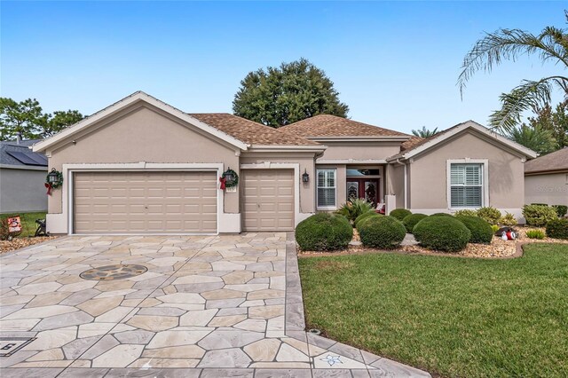 view of front of property with a front lawn and a garage