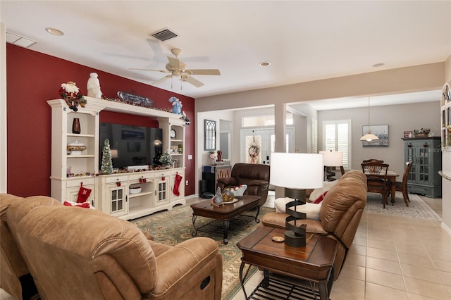 tiled living room with ceiling fan