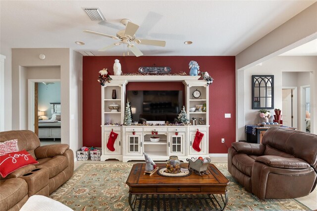 tiled living room featuring ceiling fan