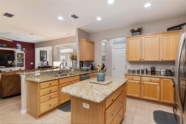 kitchen with sink, a center island, stainless steel dishwasher, and light tile patterned floors