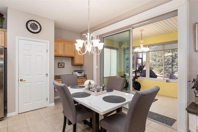 dining space featuring a notable chandelier and light tile patterned floors