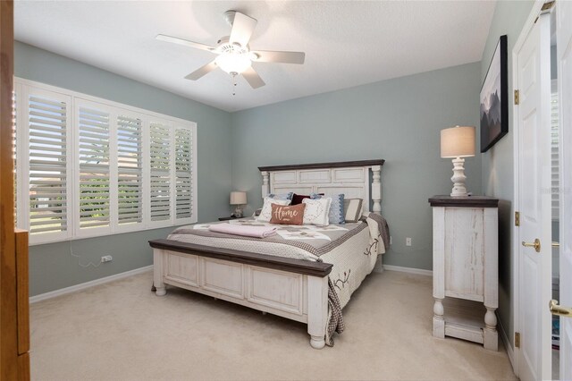 bedroom with ceiling fan and light colored carpet