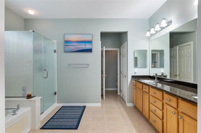 bathroom with dual vanity, tile patterned floors, and independent shower and bath