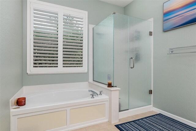 bathroom with tile patterned floors and independent shower and bath