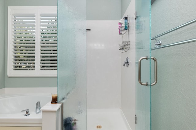 bathroom with shower with separate bathtub