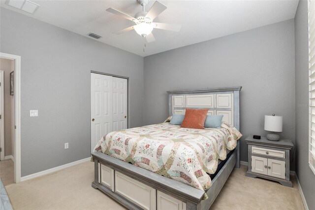 carpeted bedroom featuring a closet and ceiling fan