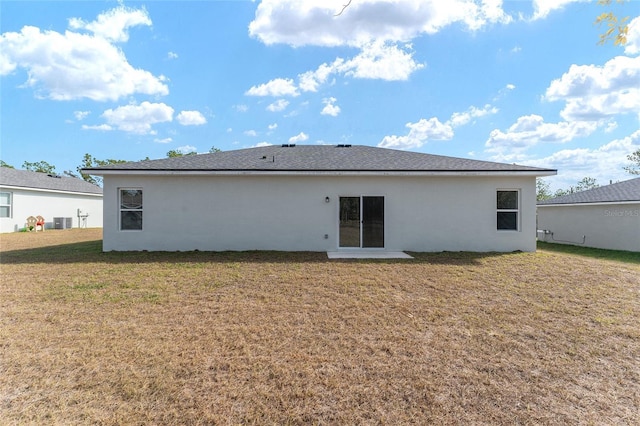 back of house with a lawn