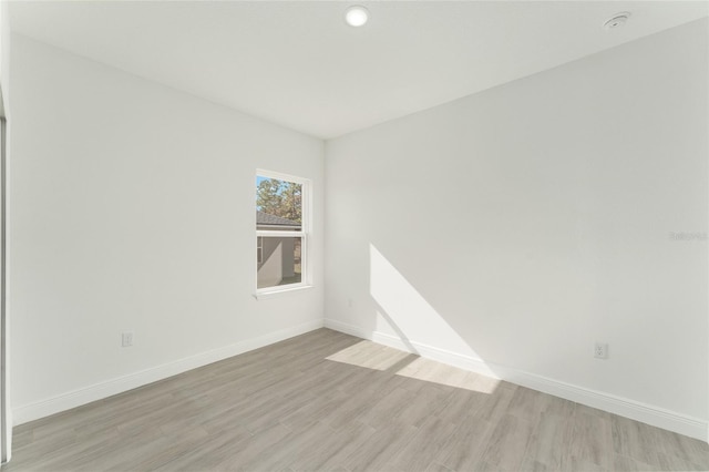 spare room featuring light hardwood / wood-style flooring