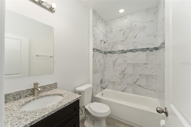 full bathroom with toilet, vanity, and tiled shower / bath