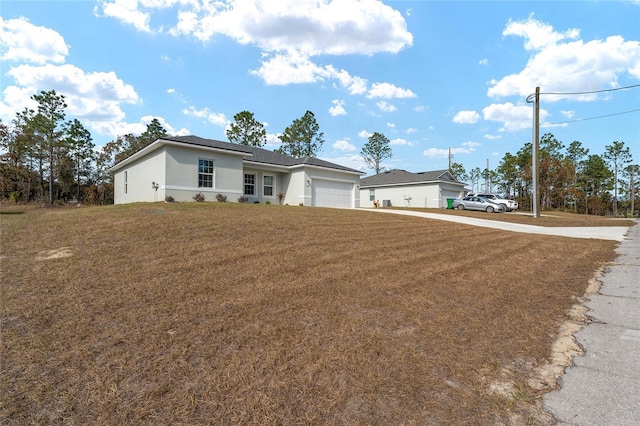 ranch-style house with a garage and a front lawn