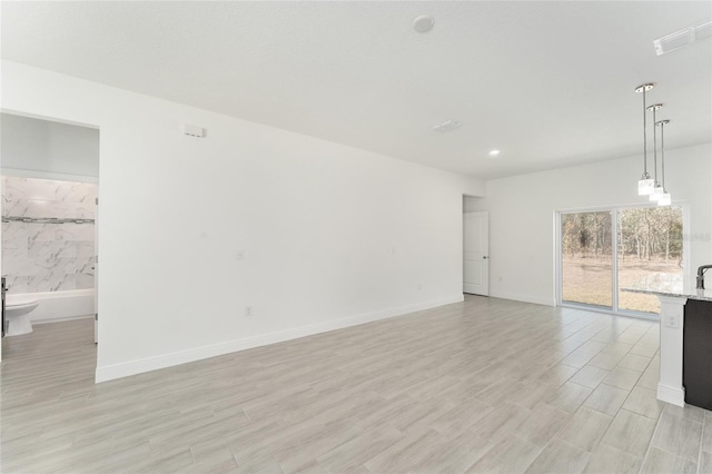 unfurnished living room with light wood-type flooring