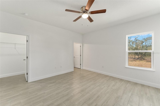 unfurnished room featuring light hardwood / wood-style flooring and ceiling fan