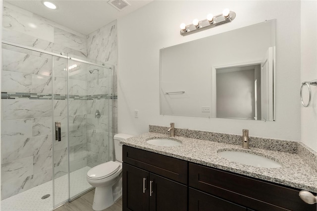 bathroom featuring vanity, toilet, and walk in shower