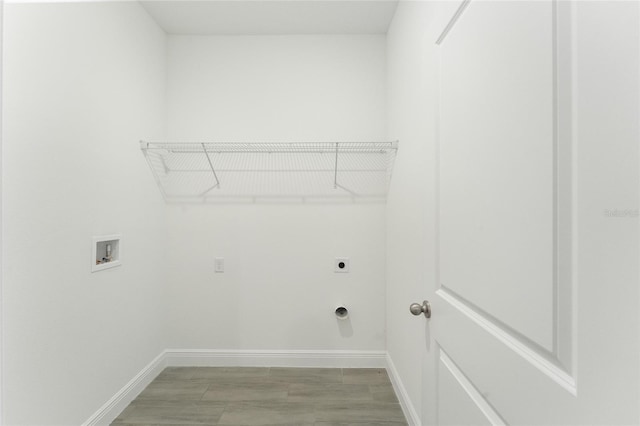 laundry room with hookup for an electric dryer, hookup for a washing machine, and light wood-type flooring