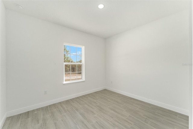 spare room with light hardwood / wood-style flooring