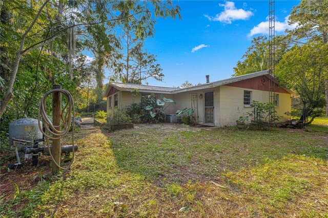 back of house with a lawn