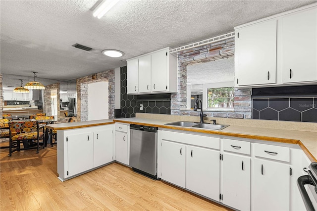 kitchen featuring white cabinets, sink, light wood-type flooring, and stainless steel dishwasher