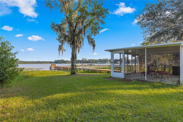 view of yard with a water view and a patio area