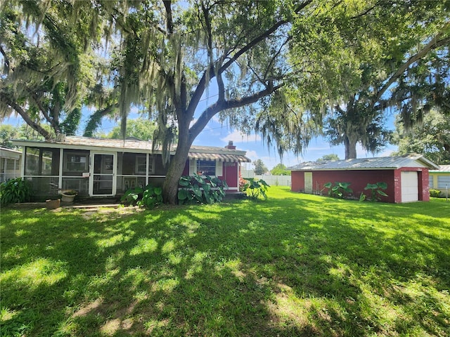 view of yard featuring an outbuilding and a sunroom