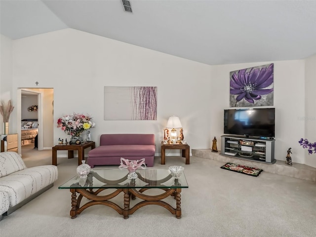 carpeted living area with lofted ceiling and visible vents