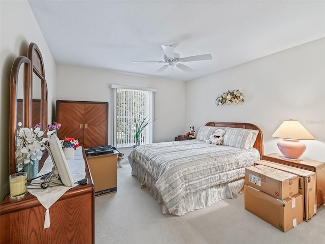 bedroom with light carpet and a ceiling fan