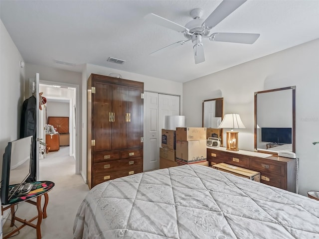 bedroom with light carpet, ceiling fan, a closet, and visible vents