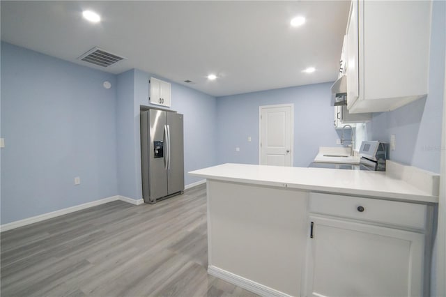 kitchen featuring stainless steel refrigerator with ice dispenser, ventilation hood, white cabinetry, light hardwood / wood-style flooring, and kitchen peninsula