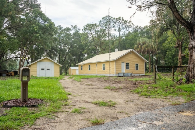 view of front of house featuring a storage unit