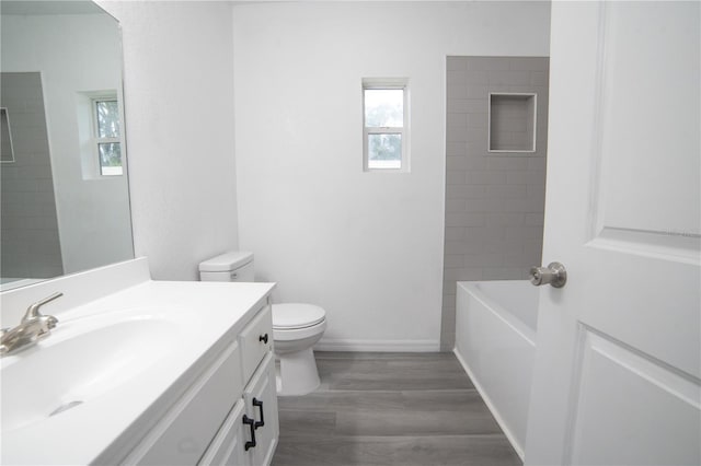 bathroom with vanity, toilet, and hardwood / wood-style floors