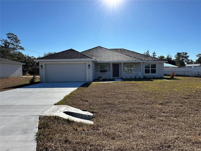 view of front of home with a front yard, a porch, and a garage