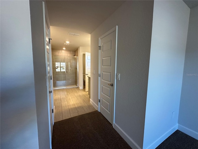 hallway with light hardwood / wood-style floors