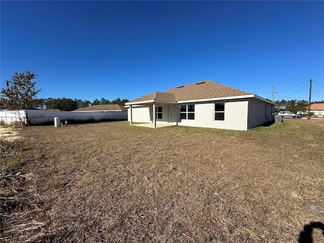 rear view of house featuring a yard