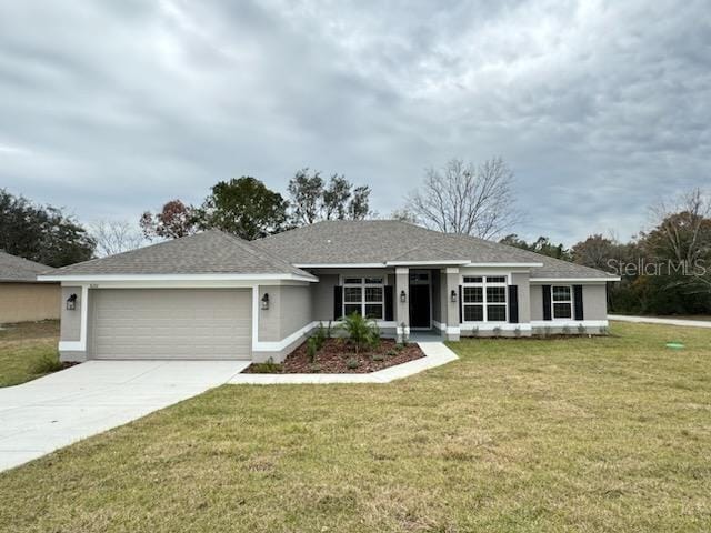 ranch-style home with a front lawn and a garage