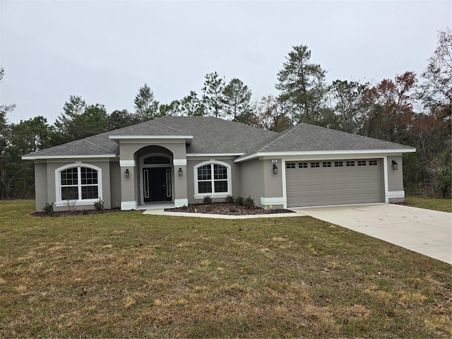 ranch-style house featuring a garage and a front yard