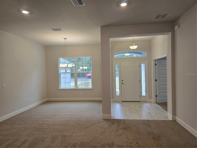 entrance foyer featuring light carpet