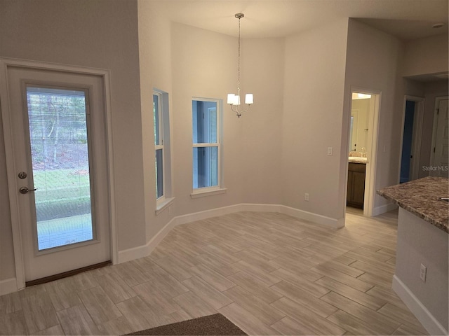 unfurnished dining area with a chandelier