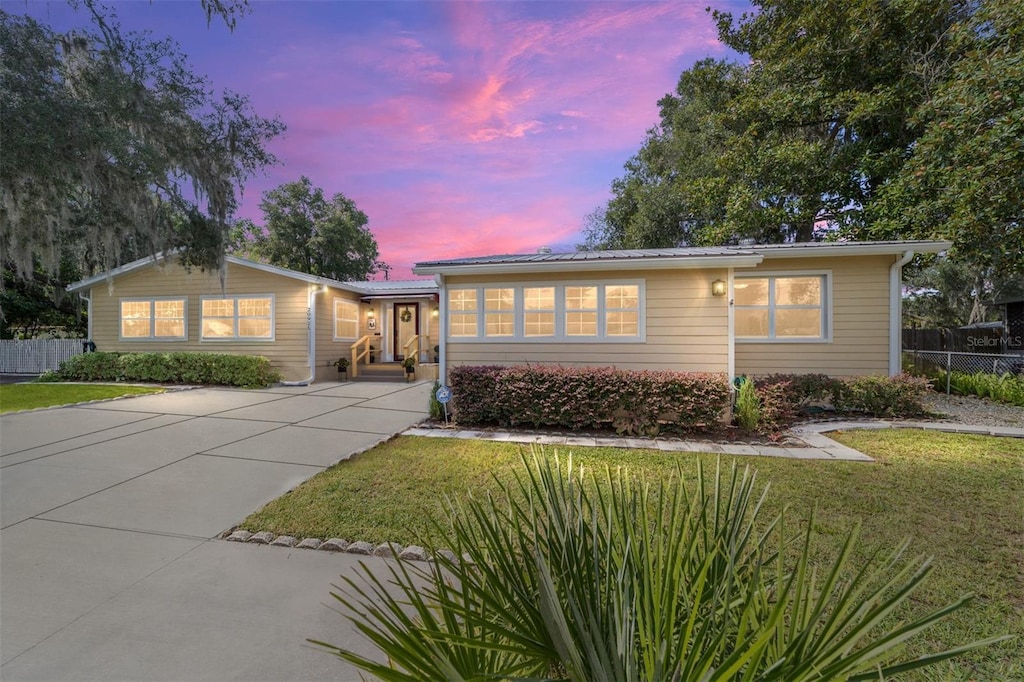 ranch-style home with a yard