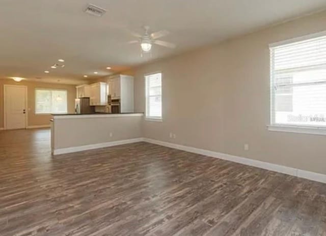 0 Fisher Lane Way, Ocklawaha, FL 32179 - unfurnished living room with a ceiling fan, dark wood-style flooring, baseboards, and recessed lighting
