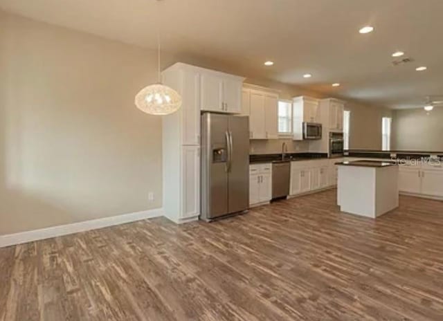 0 Fisher Lane Way, Ocklawaha, FL 32179 - kitchen with appliances with stainless steel finishes, dark wood-type flooring, recessed lighting, white cabinetry, and dark countertops