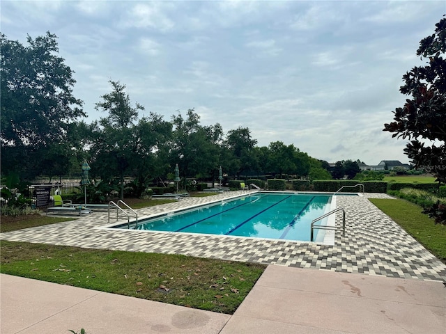 view of swimming pool featuring a patio area