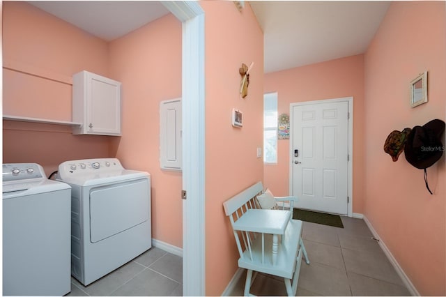 clothes washing area featuring light tile patterned floors, independent washer and dryer, cabinets, and electric panel