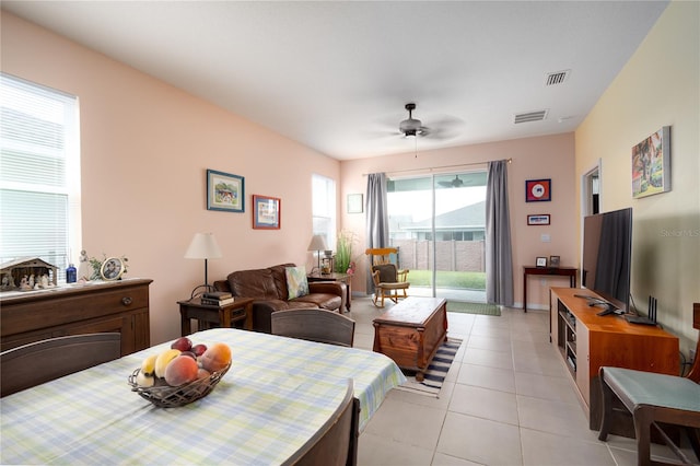 tiled dining space featuring ceiling fan