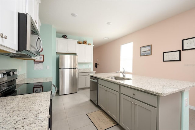 kitchen featuring gray cabinetry, light tile patterned floors, appliances with stainless steel finishes, sink, and a kitchen island with sink